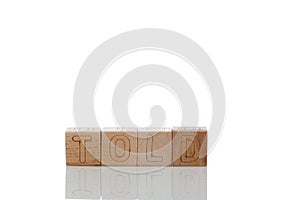 Wooden cubes with letters told on a white background