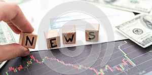 Wooden cubes with letters on a white table. The word is NEWS. White background.