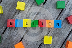 Colored wooden cubes with letters. the word billion is displayed, abstract illustration photo