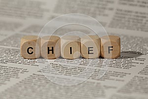 Wooden cubes with letters. the word chief is displayed, abstract illustration