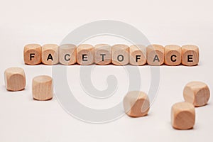 Wooden cubes with letters. the word facetoface is displayed, abstract illustration photo