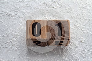 Wooden cubes with numbers on a white crumpled background. 01