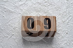 Wooden cubes with numbers on a white crumpled background. 09