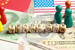 Wooden cubes with phrase Trade war on different banknotes near USA and China flags, closeup