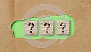 Wooden cubes with question marks, the concept of searching for truth, getting information
