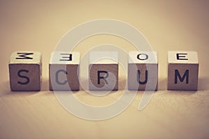 Wooden cubes showing the word scrum on a table