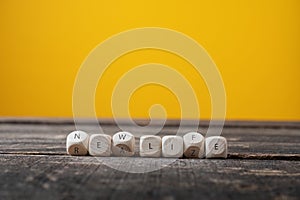 Wooden cubes spelling Realize - new life