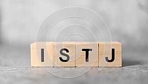 Wooden cubes with text ISTJ. Introversion, Sensing, Thinking, Judging. Personality type. Close-up