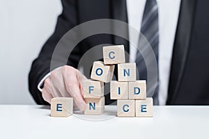 Wooden cubes with word confidence, business success, strategy, growth, confidence concept