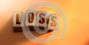 Wooden cubes with word LOSS. Financial loss or unprofitable busines concept