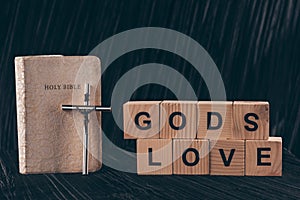 wooden cubes with words Gods Love and bible photo