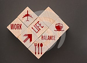 Wooden Cubes with words on them: Work Life Balance and icons. Business and enjoy choice and priority concept