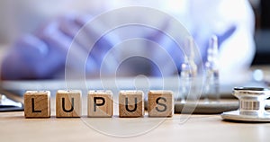 Wooden cubes written lupus on the doctor's table