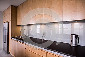 Wooden cupboards and black worktop