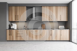 Wooden cupboards in modern gray kitchen