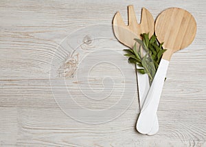 Wooden cutlery with mint leaves on wooden table. Place for your text. Top view