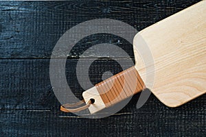 Wooden cutting Board on black background.
