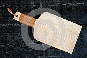 Wooden cutting Board on black background.