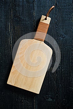 Wooden cutting Board on black background.