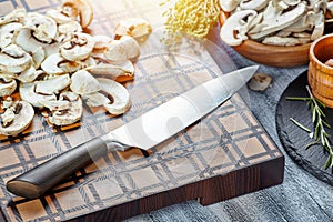 Wooden cutting board with chopped mushrooms