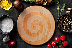 Wooden cutting board with cooking ingredient and herbal spices