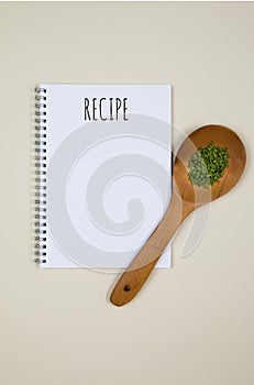 Wooden cutting board with food spices, spoon, eggs and garlics