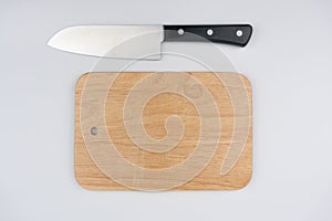 Wooden cutting board and knife  on white background, Top view. Space for text.