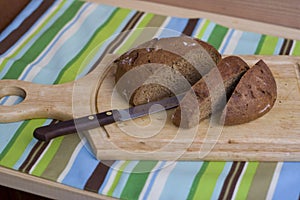 Wooden cutting board with sliced bread