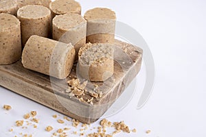 Wooden cutting board with sweets made from peanuts known in Brazil as paÃ§oca