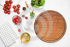 Wooden cutting board, vegetables and spices for cooking