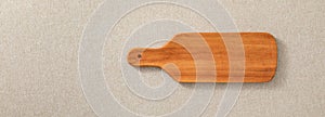 Wooden cutting board. Wooden chopping board. Handmade wood cutting board on the linen.