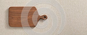 Wooden cutting board. Wooden chopping board. Walnut handmade wood cutting board on the linen.