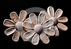 Wooden daisies on a black background