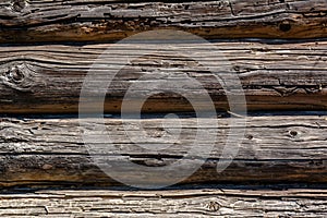 Wooden dark brown logs background with cracks and splits