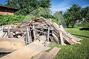 Wooden debris at the yard, boards and plates. Construction and reconstruction