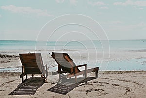 Wooden deck chairs on the beach on a Sunny day