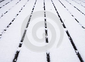 Wooden deck covered with snow converging lines