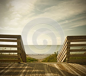 Wooden deck with fence overlooking the ocean and the beach