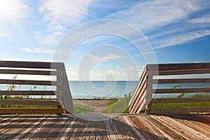 Wooden deck with fence overlooking the ocean and the beach