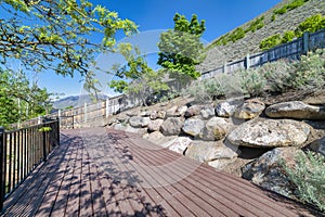 Wooden deck with metal railings at the side of the mountain