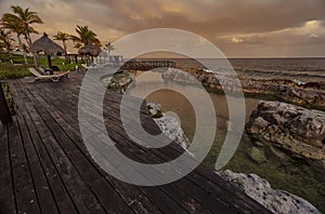 Wooden deck overlooking tranquil inlet at sunset in puerto aventuras photo