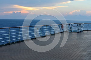 Wooden deck and railing from cruise ship. Beautiful sunset and ocean view