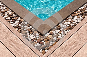 Wooden deck and stone at the corner of swimming pool