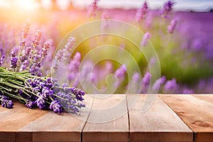 Wooden deck table with a bunch of lavender and lavender field blurred background.
