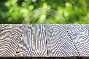 Wooden deck table over bokeh background