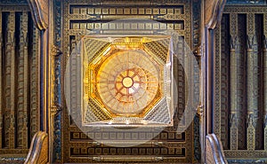 Wooden decorated dome mediating ornate ceiling with floral pattern decorations at al Ghuri Mausoleum, Cairo, Egypt