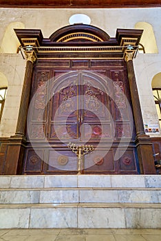 Wooden decorated entrance of historic Jewish Maimonides Synagogue with arched windows and chandelier, Cairo Egypt photo