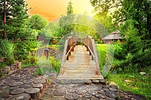 Wooden decorative bridge in the estate with landscaping