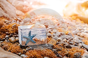 Wooden decorative Chest with sea shells and blue star on the sea coast