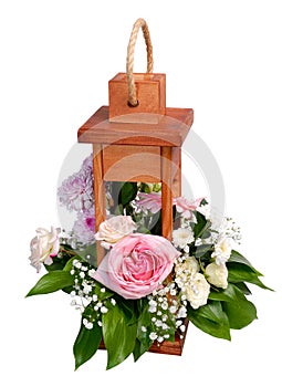 Wooden decorative lantern with flowers over white.